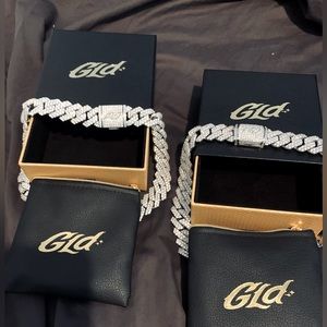 His and hers white gold Cuban link chokers